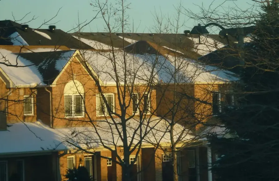 Snow covered residential street of older brick homes in the Greater Moncton area of New Brunswick during winter